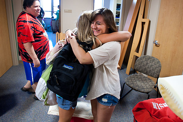 Two female undergraduates hugging.