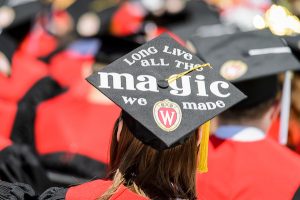 Graduates display personal messages on their graduation caps during UW-Madison's spring commencement ceremony at Camp Randall Stadium.