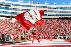 A member of the UW Spirit Squad waves a giant W flag after the Badgers score a touchdown at Camp Randall Stadium.