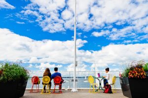 UW students and Madisonians enjoy a warm summer day on a Memorial Union Terrace balcony.