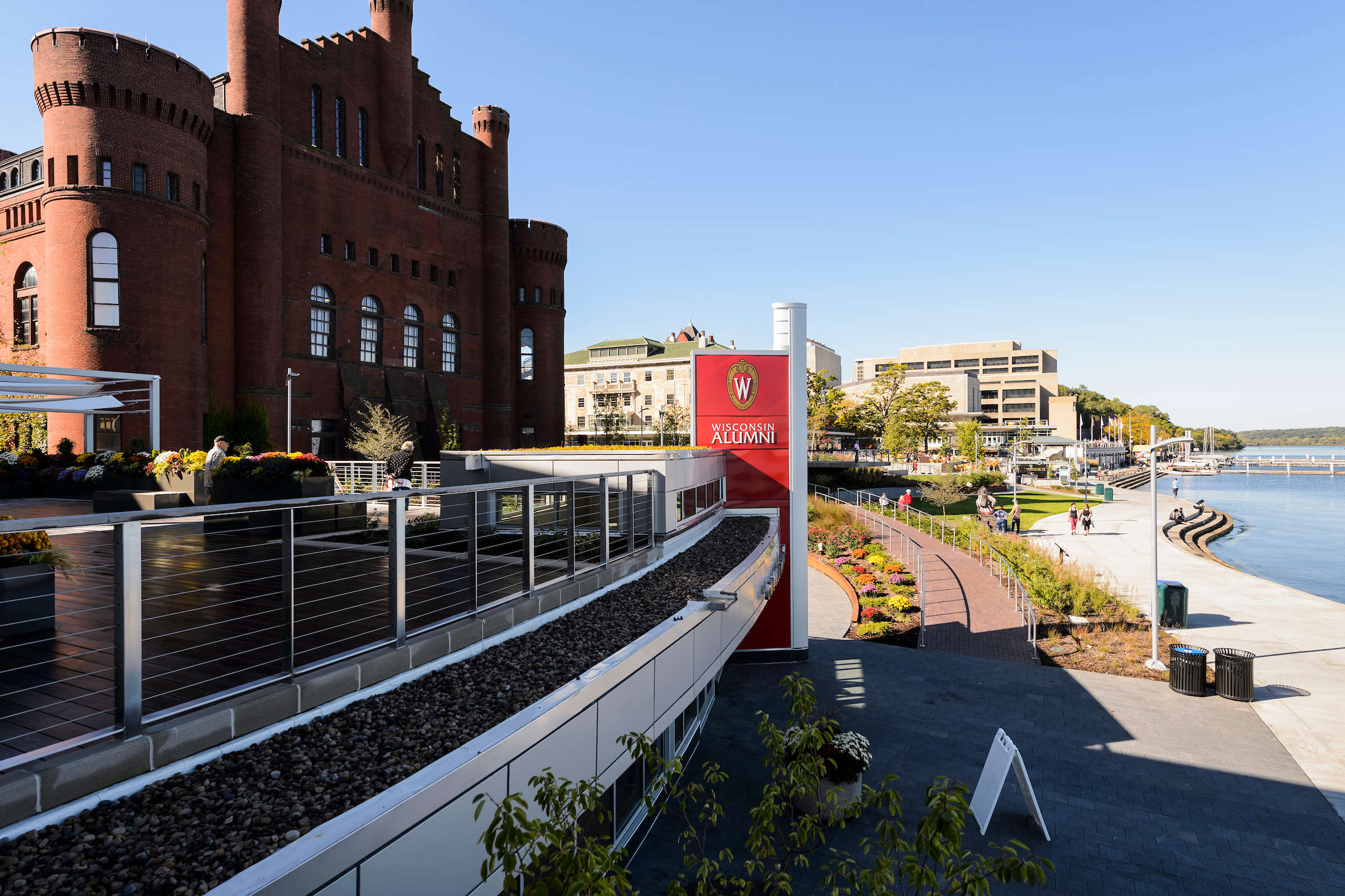 Pictured left to right along the Lake Mendota shoreline is One Alumni Place, the Red Gym (Armory and Gymnasium), Alumni Park, Memorial Union Terrace and Helen C. White Hall.