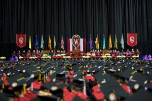 Chancellor Blank stands on the winter Commencement stage.