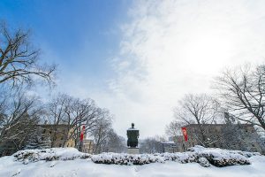 A view of the Abraham Lincoln statue, snow-covered, on top of Bascom Hill.