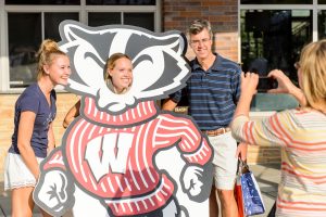  A UW student and her family pose with a large Bucky cut-out for a photo outside of Union South.