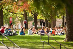 A class of students sits in a circle on Bascom Hill.