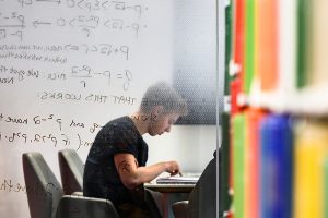 A student studies in the Wisconsin School of Business Library in Grainger Hall.