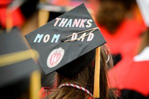 A student displays a personal message, ‘Thanks Mom & Dad’, on her graduation cap during the spring commencement ceremony.