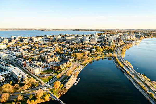 The downtown Madison Isthmus and the Wisconsin State Capitol, along with Monona Bay and John Nolen Drive, are pictured in an early morning aerial taken from a helicopter.