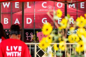 A sign reading “Welcome Badgers” is shown in the background as undergraduate students move in to Elizabeth Waters Residence Hall.