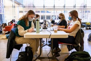 Four students sit at a table, studying, in the Chazen Museum of Art.