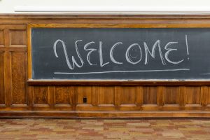 The word “welcome” is written on a classroom chalkboard in Sterling Hall.