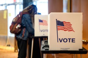 A student cast their ballots for the spring election while voting at a polling place at the Memorial Union.