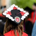 A graduate's cap, decorated with red and white flowers, is pictured