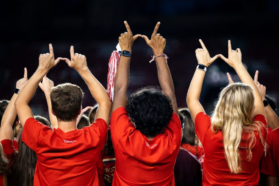 First-year students create the letter "W" with their hands during the W Project at Camp Randall Stadium.