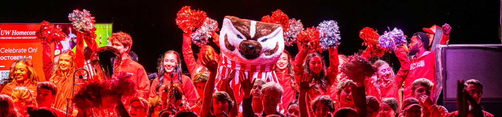 Bucky Badger, the UW Marching Band, and the Spirit Squad host a pep rally for a crowd of alumni, students, family, and friends during the Homecoming Block Party
