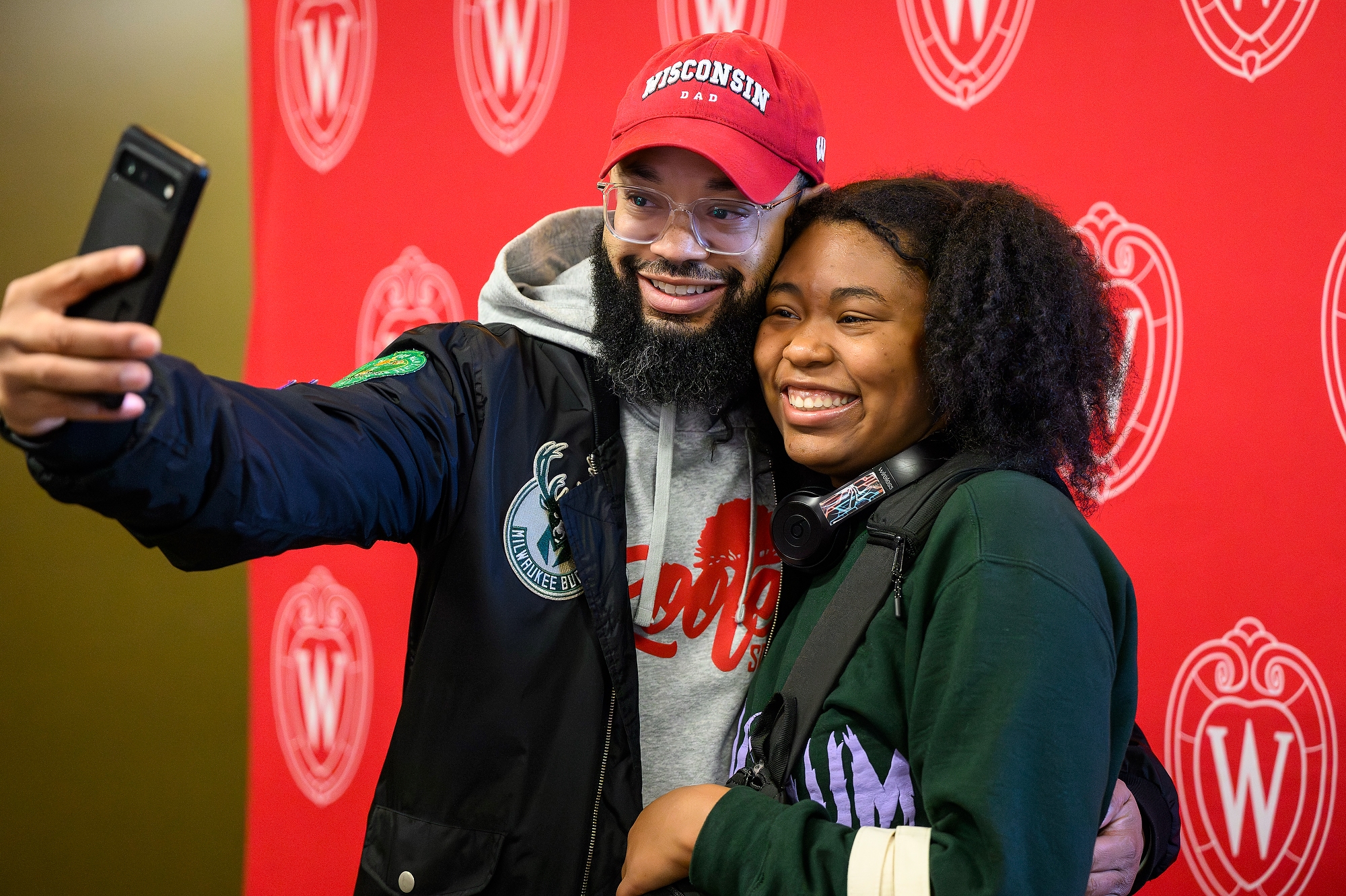 A dad takes a picture with his daughter