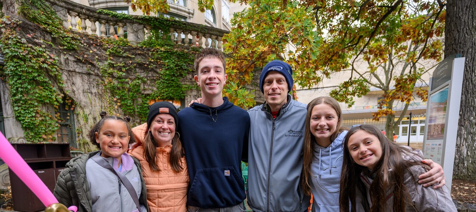 An undergraduate student poses with his parents and siblings