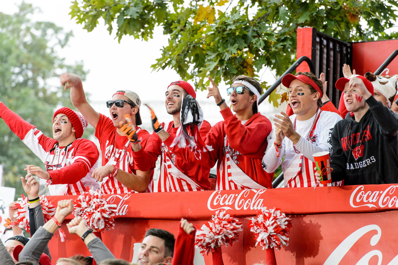 UW Badger fans with red striped overalls
