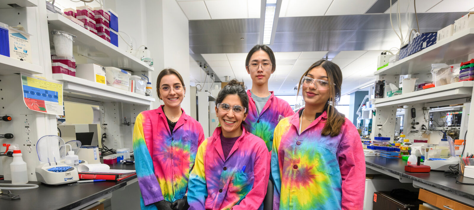 At center, seated Linda Horianopoulos, postdoctoral fellow in the Hittinger Lab at the University of Wisconsin–Madison, is pictured along with undergraduate research scholars.