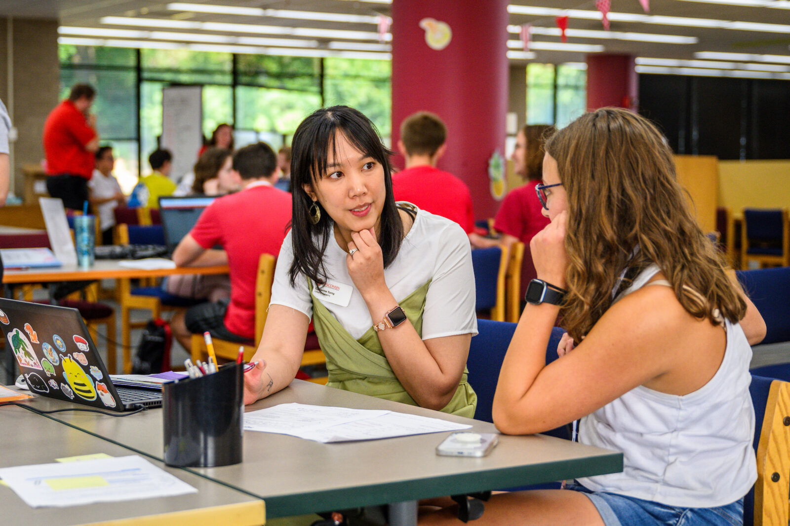 At left, an academic advisor speaks with a first-year student on right.