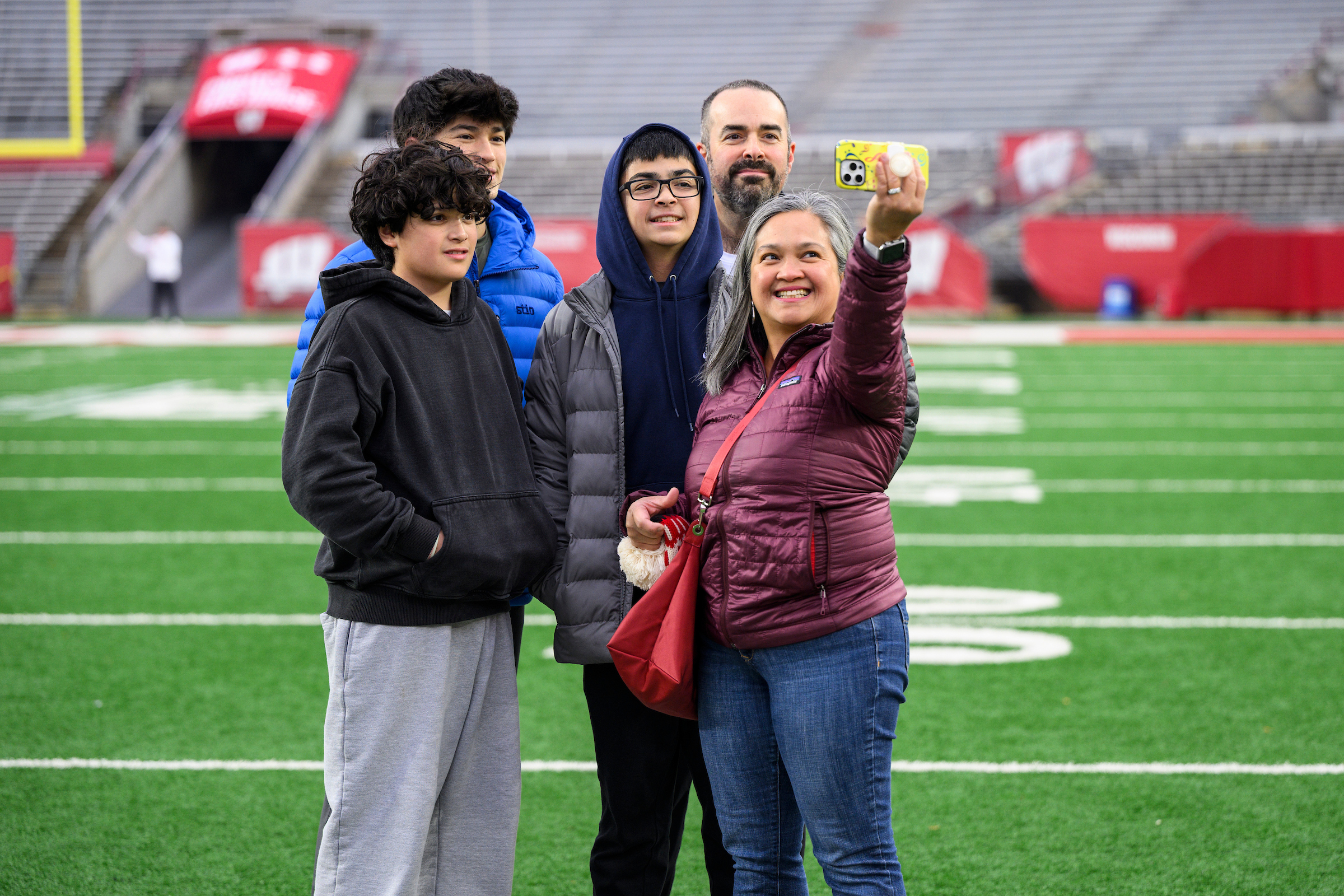 A family poses for a selfie at Camp Randall