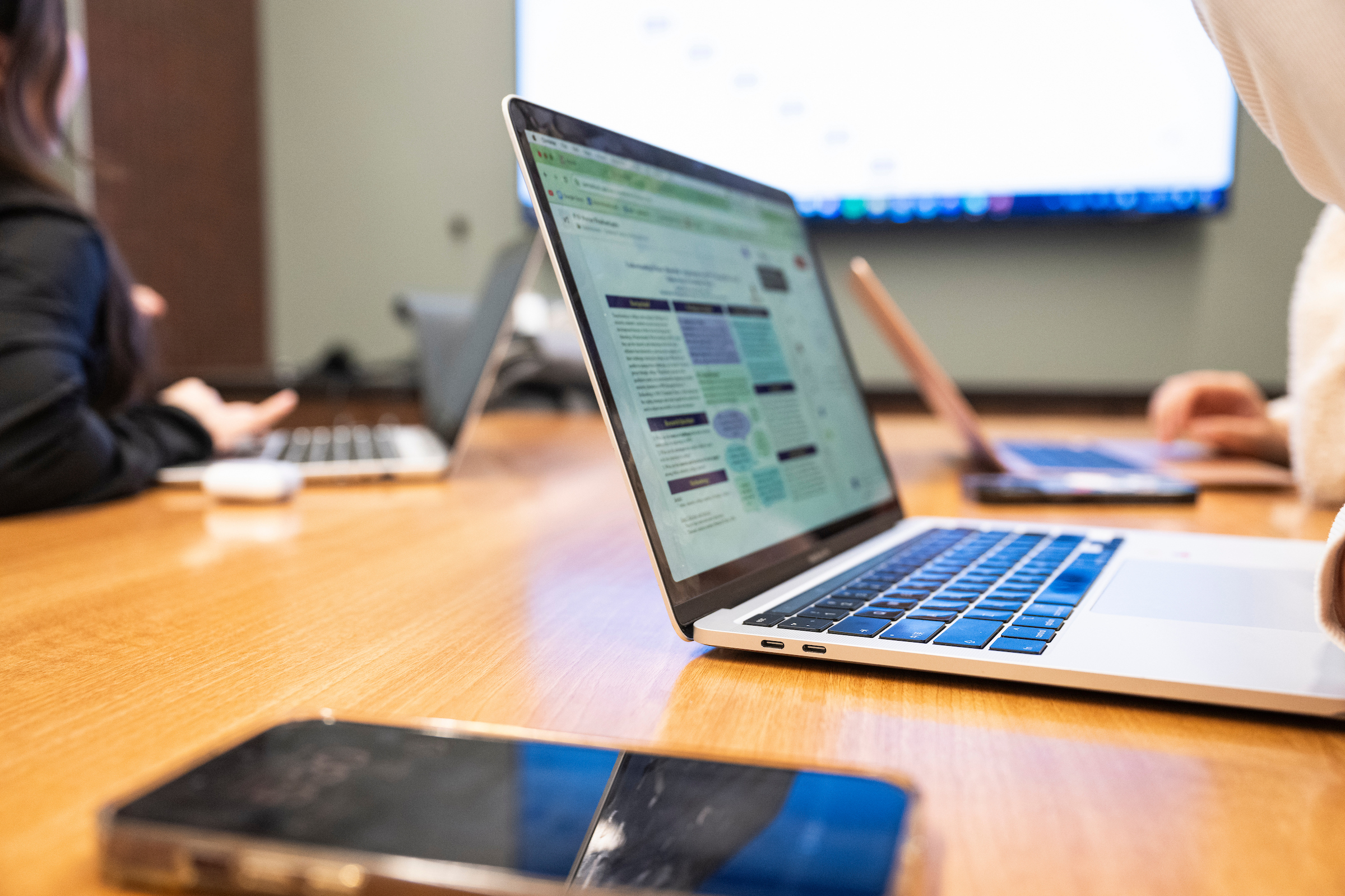 An open laptop on a wooden table