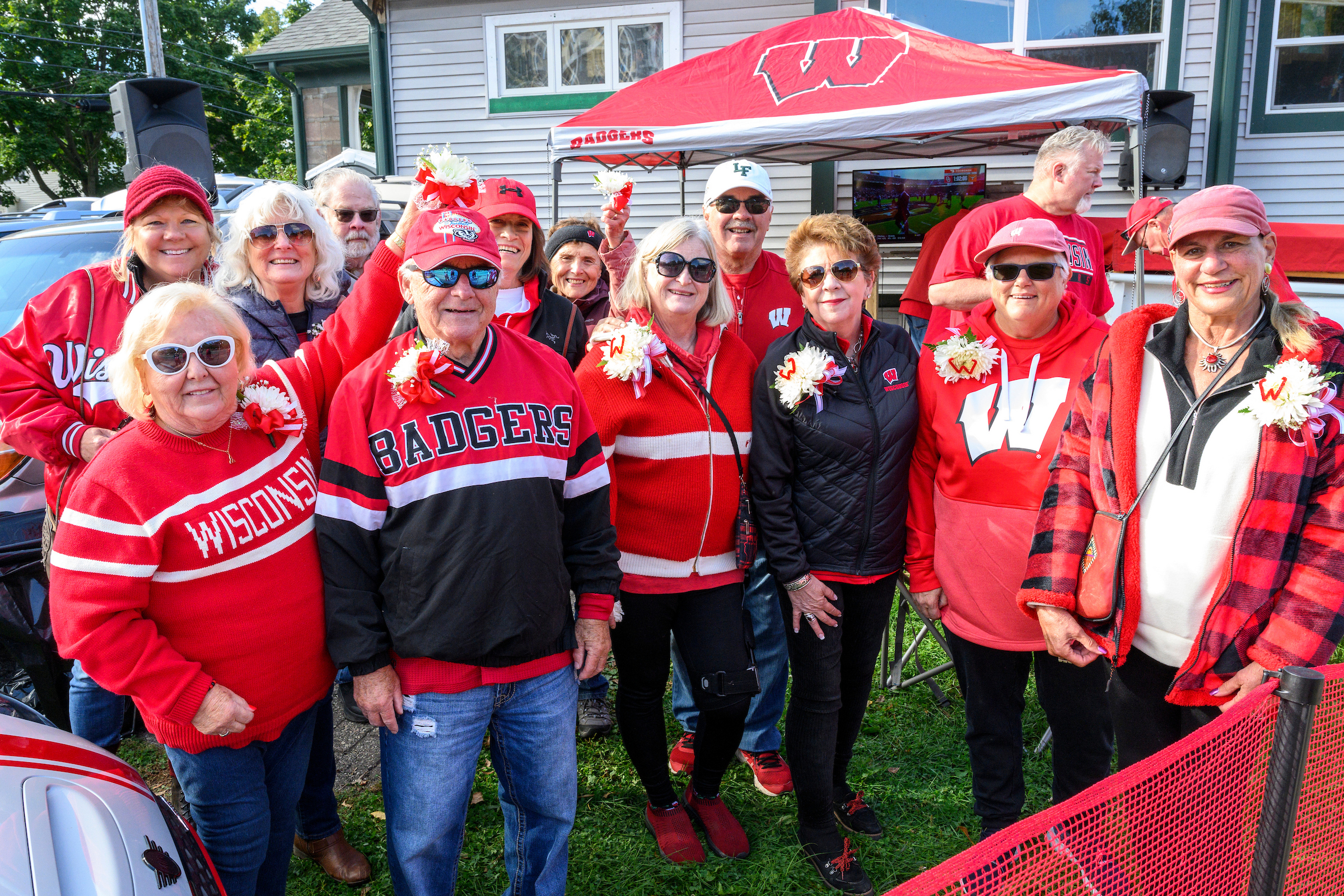Several People in Red  tailgate before a  game