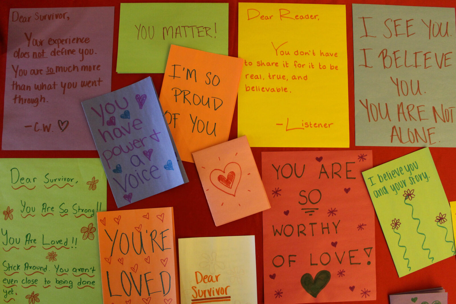 A wall of post it notes with messages of encouragement for survivors